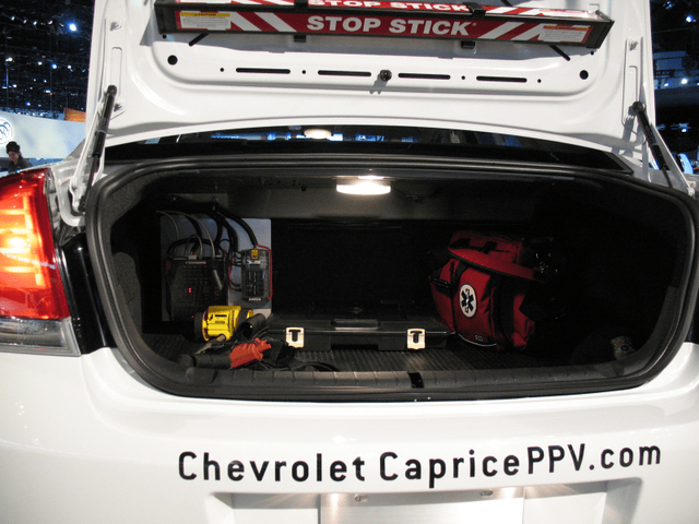 2011 Chevrolet Caprice PPV trunk open with police equipment and Stop Stick