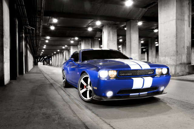 2011 Dodge Challenger SRT8 in blue with white stripes front three-quarter view in parking garage
