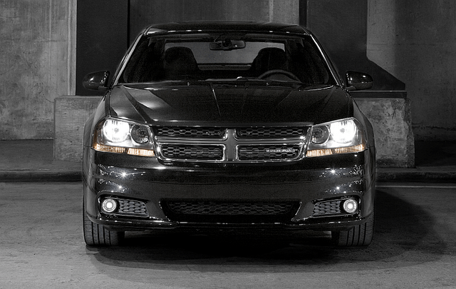 2011 Dodge Avenger front view close-up with headlights illuminated