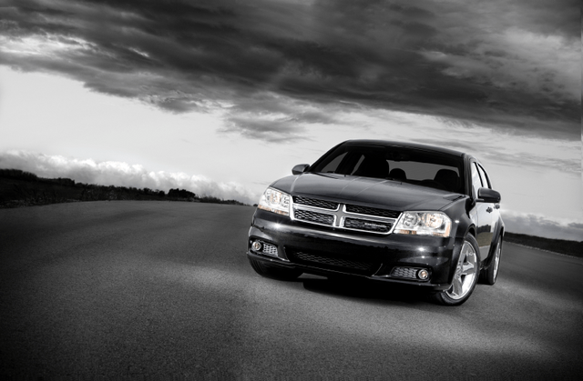 2011 Dodge Avenger front three-quarter view on road in black and white