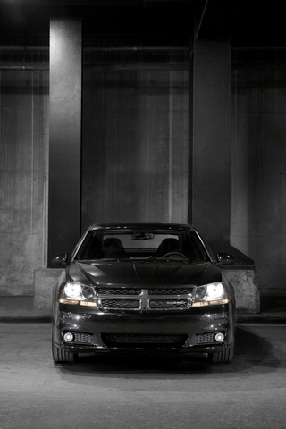 2011 Dodge Avenger front view in parking garage with headlights on