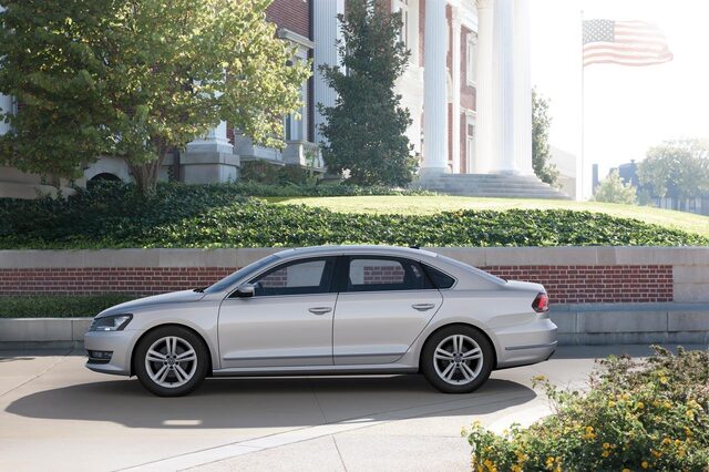 2012 Volkswagen Passat TDI Right Profile View at Brick Building with Flag