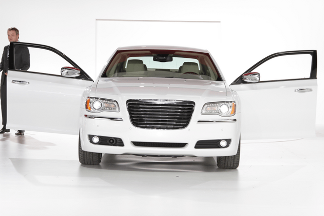 2011 Chrysler 300 white front view with doors open at reveal event
