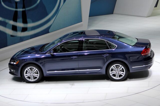 2012 Volkswagen Passat passenger side profile dark blue auto show