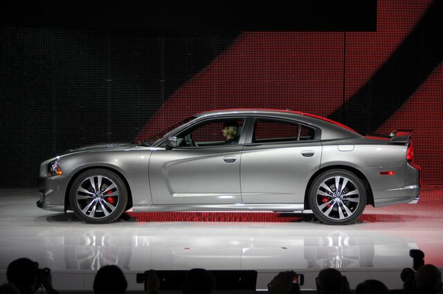 2012 Dodge Charger SRT-8, passenger-side profile view on auto show stage