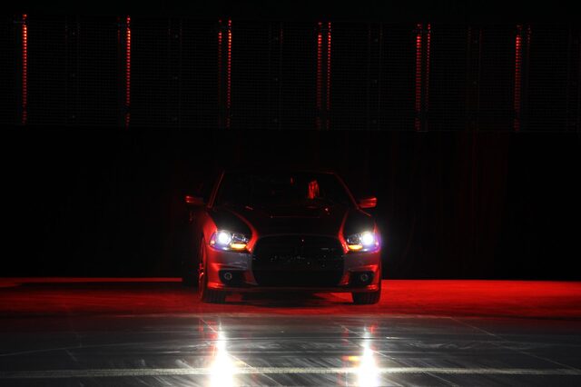 2012 Dodge Charger SRT-8, dark pre-reveal teaser shot with headlights and red floor lighting