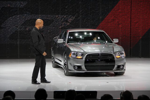 2012 Dodge Charger SRT-8, front three-quarter view on auto show stage with presenter