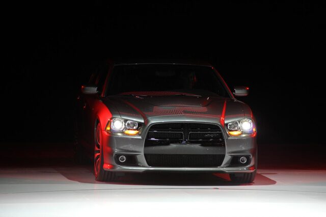 2012 Dodge Charger SRT-8, dramatic low-light front view with headlights cutting through darkness