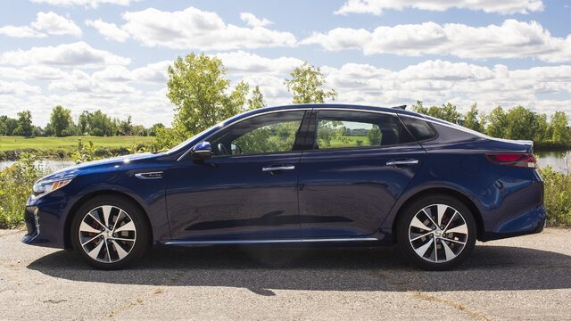2016 Kia Optima SXL Driver Side Profile Parked Near Lake with Summer Foliage