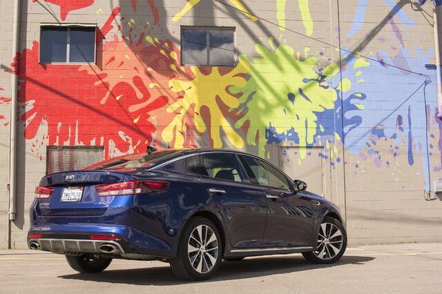 2016 Kia Optima SXL Rear Three-Quarter View in Front of Colorful Graffiti Mural Wall
