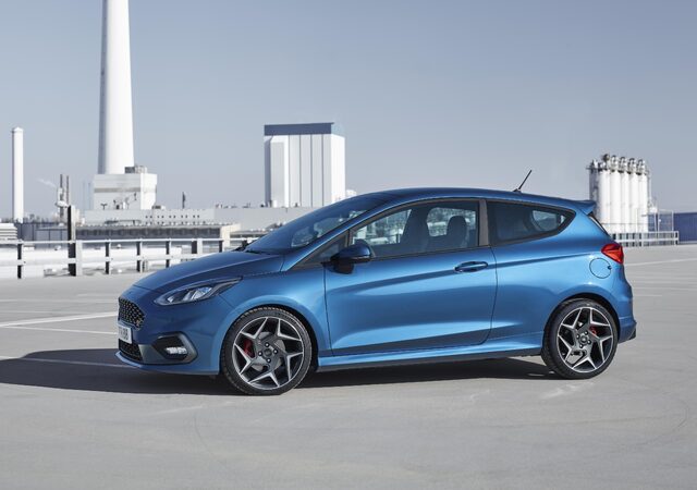 2018 Ford Fiesta ST blue hatchback side view on rooftop parking deck