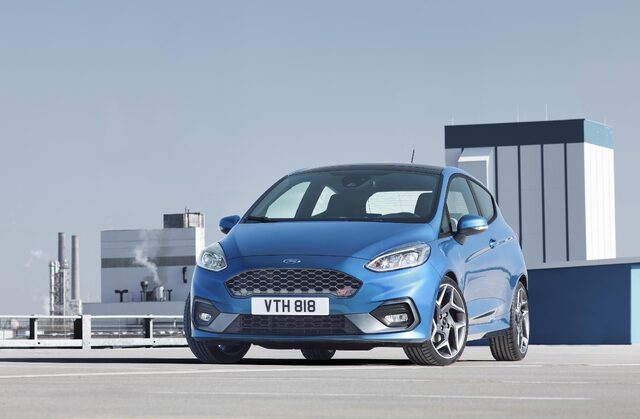 2018 Ford Fiesta ST blue hatchback front three-quarter view on rooftop parking deck