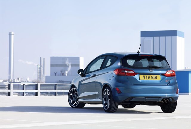 2018 Ford Fiesta ST blue hatchback rear three-quarter view on rooftop parking structure