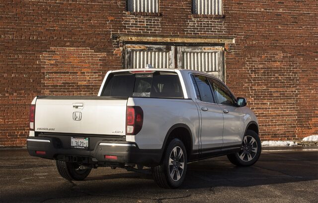 2017 Honda Ridgeline RTL-E rear three-quarter view against brick building
