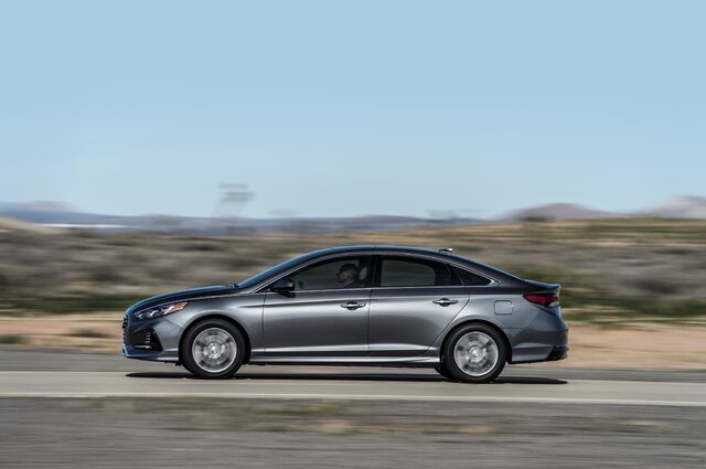 2018 Hyundai Sonata Sport gray sedan side profile in motion on desert highway