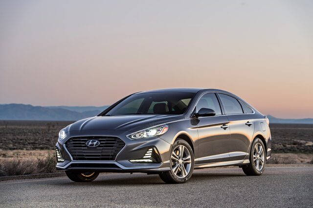2018 Hyundai Sonata Sport gray sedan front three-quarter view at dusk in desert