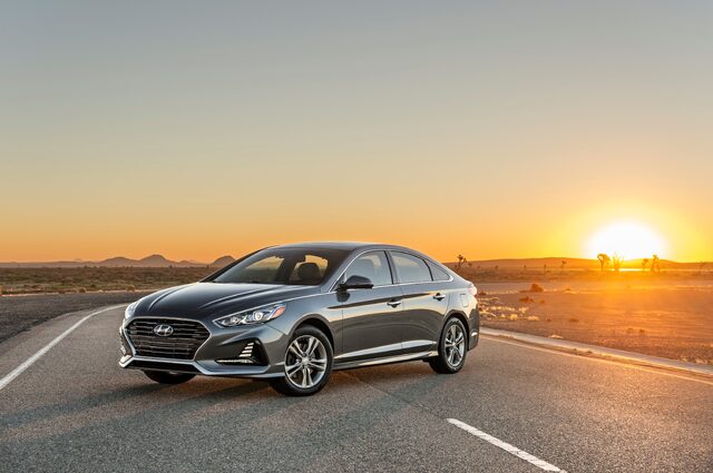 2018 Hyundai Sonata Sport gray sedan front three-quarter view at sunset in desert landscape