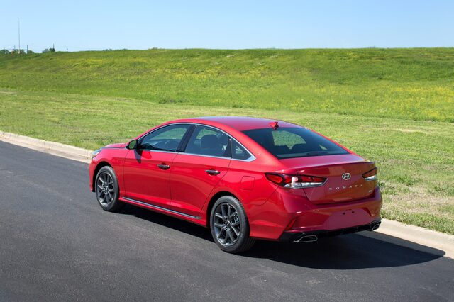 2018 Hyundai Sonata Sport 2.0T red sedan rear three-quarter view parked on pavement
