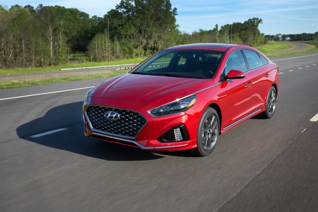 2018 Hyundai Sonata Sport 2.0T red sedan front three-quarter view in motion on highway
