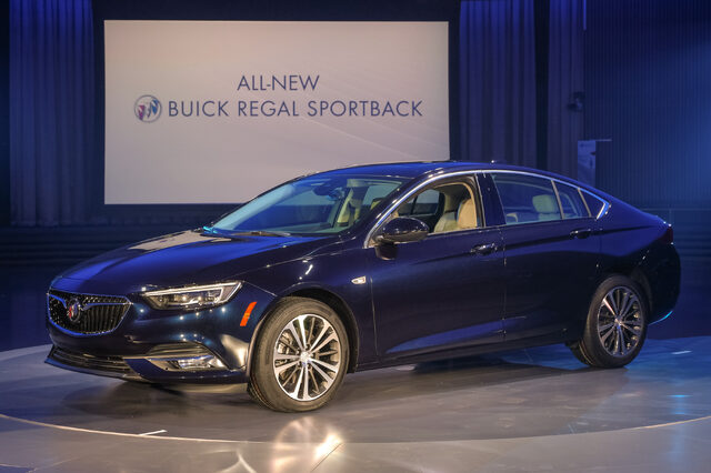 2018 Buick Regal Sportback blue front three-quarter at reveal with signage