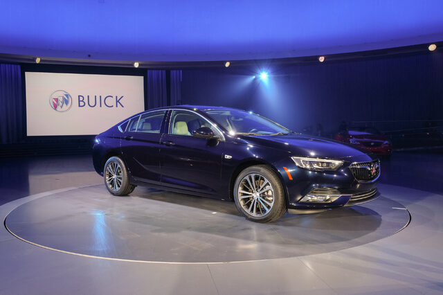 2018 Buick Regal Sportback blue on reveal stage with TourX visible in background
