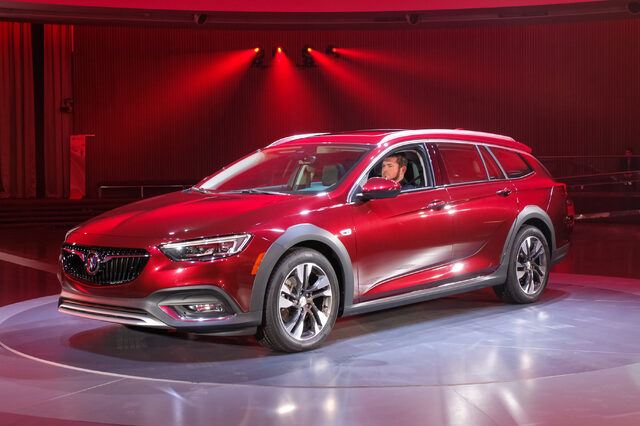 2018 Buick Regal TourX red front three-quarter on stage at live reveal