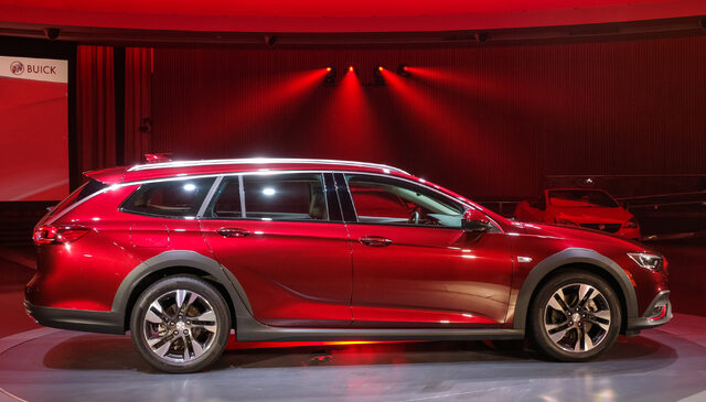 2018 Buick Regal TourX red side profile on stage at live reveal