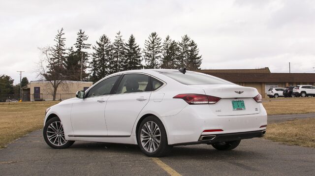 2017 Genesis G80 3.8 HTRAC Rear Three-Quarter View with Pine Trees and School Building
