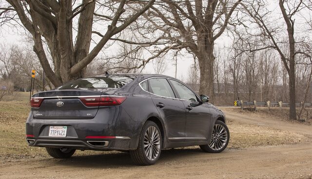 2017 Kia Cadenza Limited Rear Three-Quarter View on Dirt Road with Bare Trees