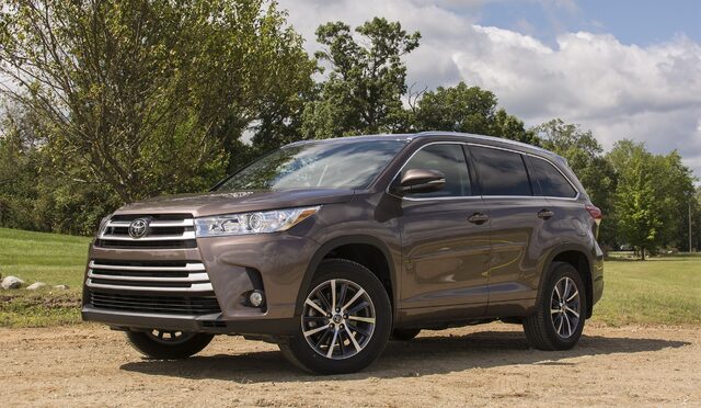 2017 Toyota Highlander XLE AWD Front Three-Quarter View on Gravel Lot with Cloudy Summer Sky