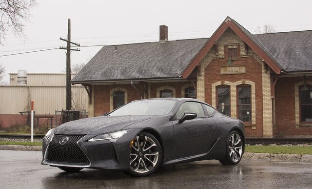 2018 Lexus LC 500 front three-quarter beside historic depot