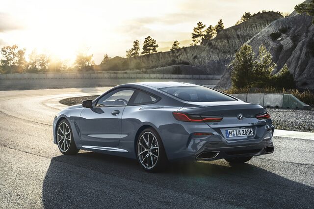 2019 BMW M850i xDrive rear three-quarter view at sunset