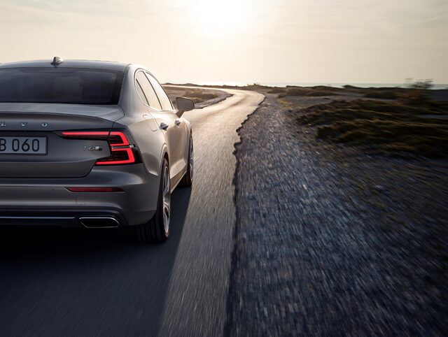 2019 Volvo S60, rear view driving on coastal road