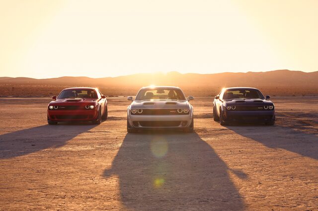 2019 Dodge Challenger, three-car front lineup at sunset backlit on desert dry lake