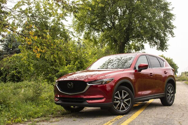 2018 Mazda CX-5 Grand Touring front three-quarter view in Soul Red Crystal