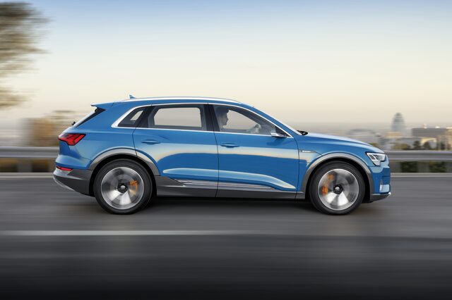 2019 Audi e-tron quattro side profile in motion on bridge