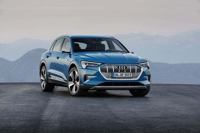2019 Audi e-tron quattro front three-quarter view layered mountain setting