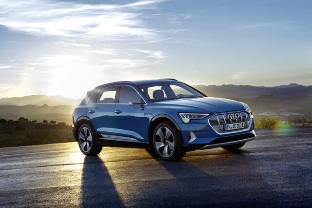 2019 Audi e-tron Antigua Blue front three-quarter view mountain golden sunset