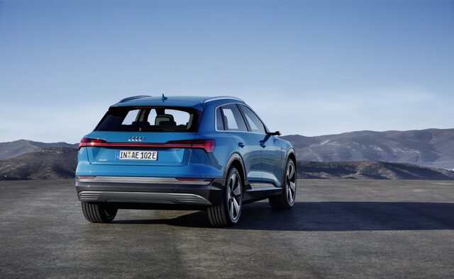 2019 Audi e-tron Antigua Blue rear three-quarter view in mountain setting