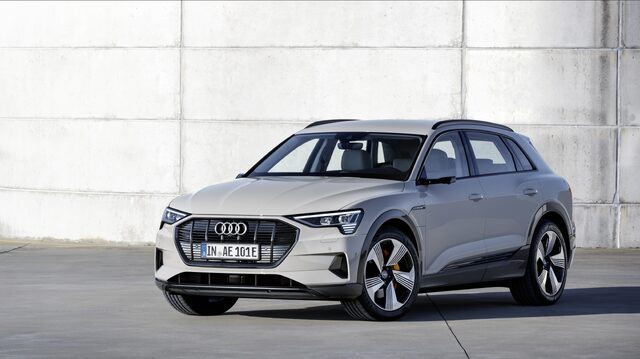 2019 Audi e-tron silver front three-quarter view against concrete wall