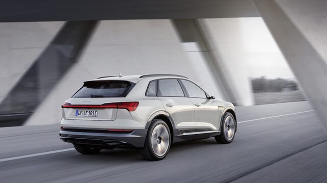 2019 Audi e-tron white rear three-quarter view in motion through underpass