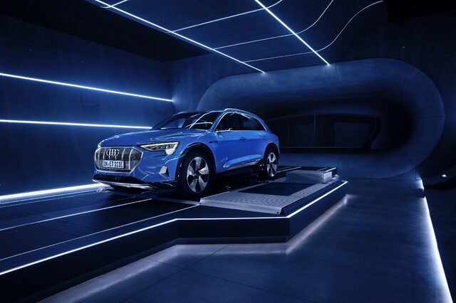 2019 Audi e-tron Antigua Blue front three-quarter view in dramatic blue lighting