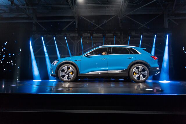 2019 Audi e-tron Antigua Blue side profile on illuminated premiere event stage