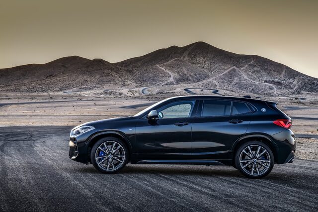 2019 BMW X2 M35i side profile on desert racetrack at dusk