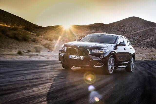 2019 BMW X2 M35i front three-quarter view at sunset with lens flare
