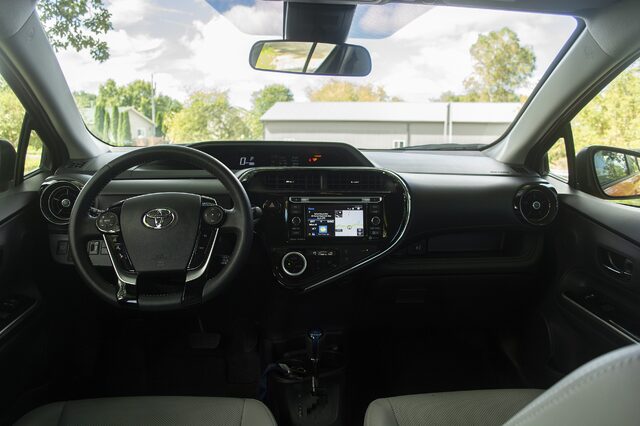2018 Toyota Prius C Four interior dashboard with panoramic roof