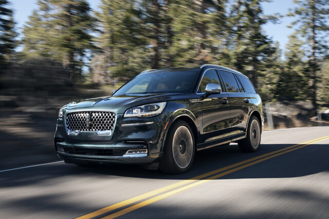 2020 Lincoln Aviator [front three-quarter driving forest]