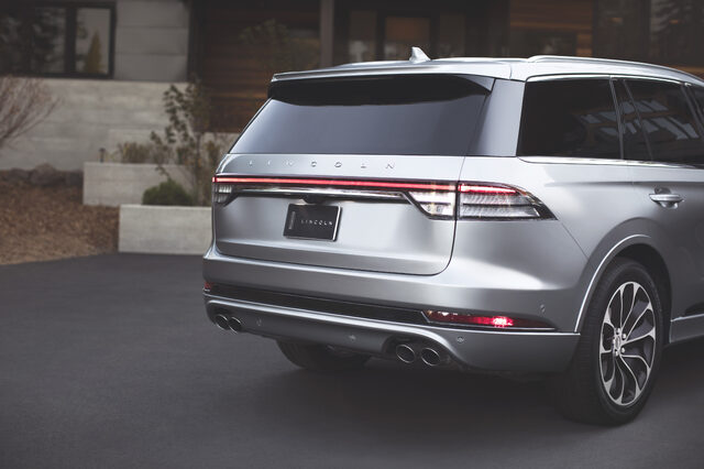 2020 Lincoln Aviator Grand Touring, rear view parked at modern home