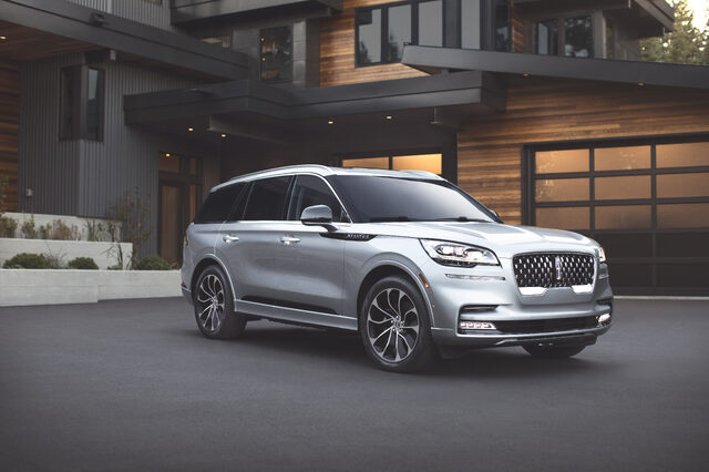2020 Lincoln Aviator Grand Touring, front three-quarter parked at modern home
