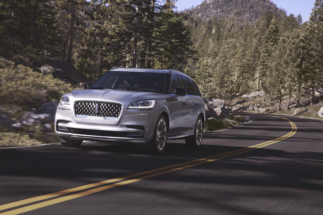 2020 Lincoln Aviator Grand Touring, front three-quarter action shot in forest